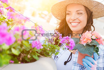 Young Adult Woman Wearing Hat and Gloves Gardening Outdoors