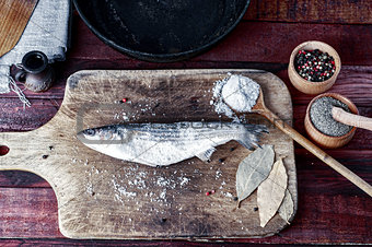 Fresh fish smelt spices for cooking on a kitchen board