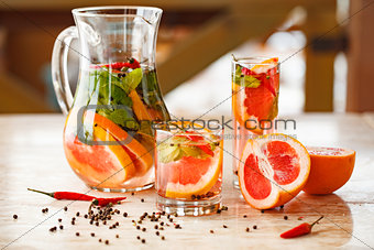 grapefruit mint lemonade on table with pepper and chili