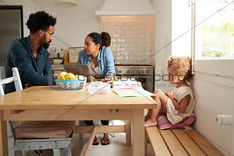 Unhappy Girl Watching Parents Arguing In Kitchen