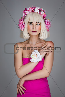 Beautiful girl in pink dress with floral head accessory