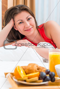 Vertical portrait of a brunette in bed and breakfast