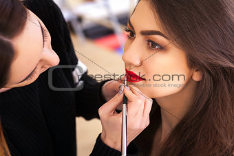 make-up artist doing make-up girl in the salon, beauty concept