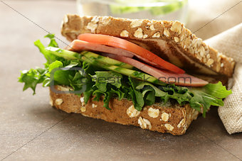 wholegrain sandwich with ham, tomato, cucumbers  and pickles