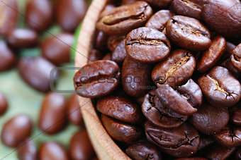 brown coffee beans on a wooden background