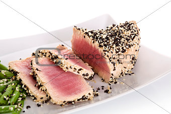 Tuna slices with white and black sesame seeds.