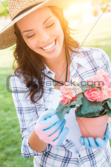 Young Adult Woman Wearing Hat and Gloves Gardening Outdoors