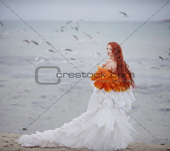 beautiful girl like a swan on the beach