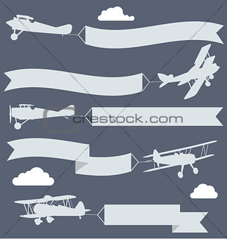 Silhouettes of biplanes with wavy greetings banner