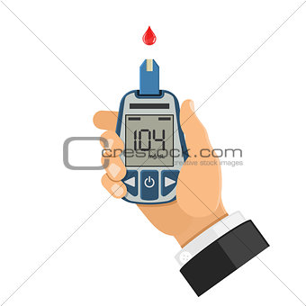 blood glucose meter in hand