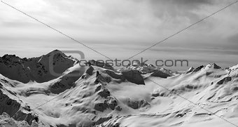 Black and white panorama of Caucasus Mountains in snow winter ev