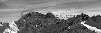 Black and white panorama on winter snow mountains