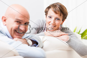 Relaxed friendly couple smiling at the camera