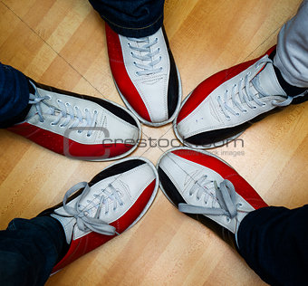 children's feet in shoes and a bowling ball