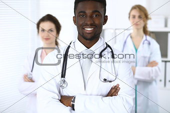 Happy african american male doctor  with medical staff at the hospital