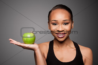 Happy healthy black asian woman with apple