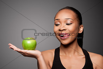 Happy healthy black asian woman with delicious apple