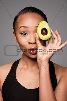 Happy healthy black asian woman with avocado fruit