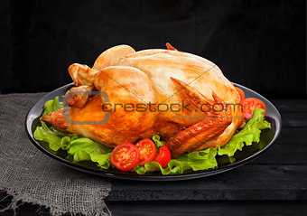 Roasted chicken on black background