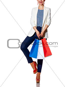 Happy woman with shopping bags posing against white background