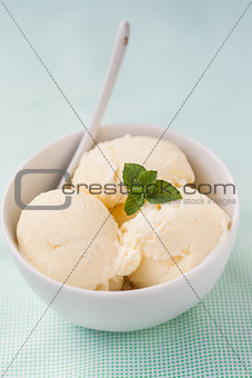 balls of vanilla ice cream decorated with mint leaves