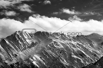 Black and white snow winter mountains and cloud sky in sun eveni