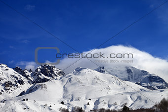Mountains in clouds and off-piste slope in winter