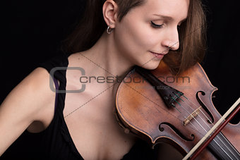 beautiful woman playing violin studio portrait on black