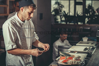 Preparing sushi set in restaurant kitchen
