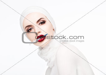 Beautiful model holding syringe in lips surgery
