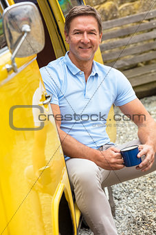 Handsome Middle Aged Man Drinking Tea coffee in Camper Van Bus