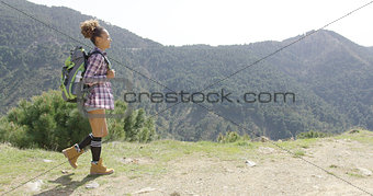 Sportive woman with backpack in mountains