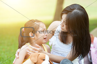 Mother comforting crying child.