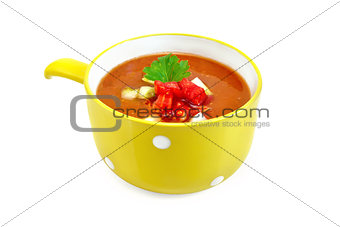 Soup tomato with parsley in yellow bowl