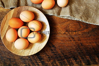 Rustic wooden table with egg. Top view.