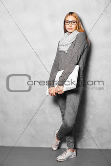 Cute girl against grey wall