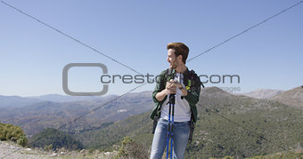 Young male with trekking poles looking away
