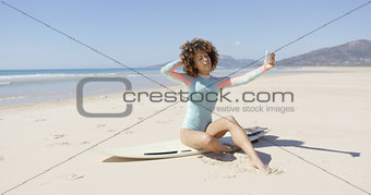 Female taking selfie on sea background