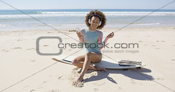 Female listening music on beach