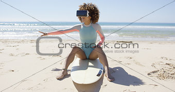 Female wearing virtual reality glasses on beach