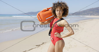 Female posing with rescue float on beach