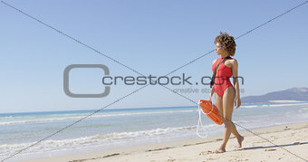 Lifeguard female with rescue float