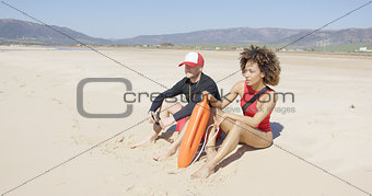 Female and male lifeguards patrolling beach