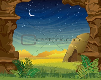 Prehistoric landscape with cave and wall of rock.
