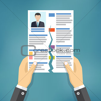 Hands holding ripped CV profile.