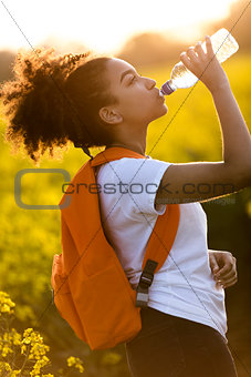 Mixed Race African American Girl Teenager Drinking Water at Suns