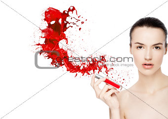 Beautiful model with lipstick tube paint splashes