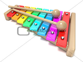Xylophone with rainbow colored keys and with two wood drum stick