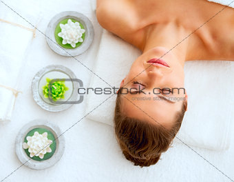 Portrait of young woman laying on massage table