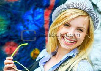 Portrait of smiling hipster girl with sunglasses outdoors